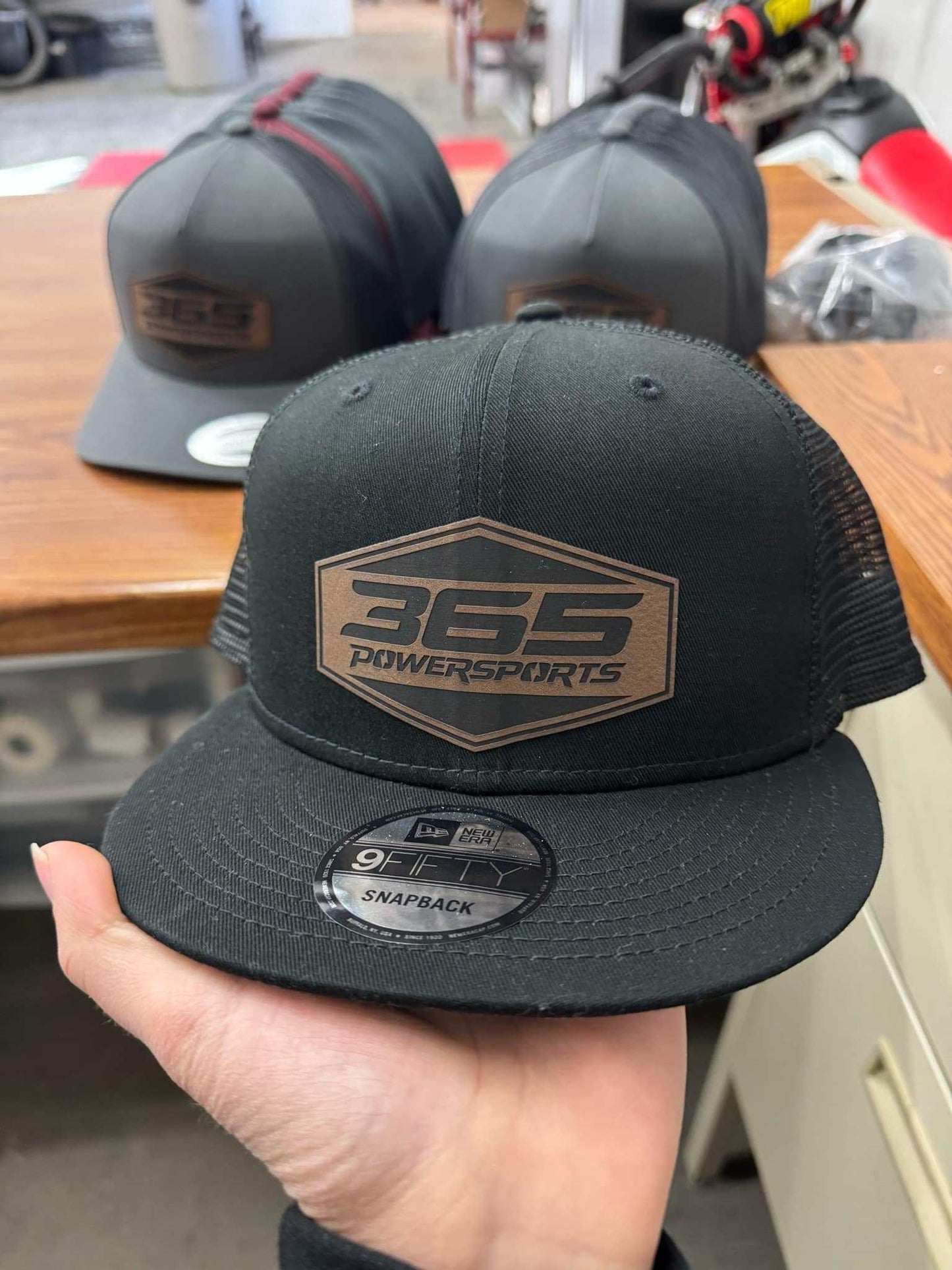365 Powersports New Era leather patch hat on display.