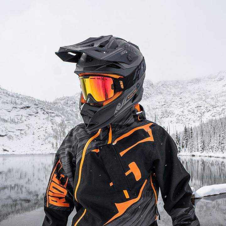 Snow sports enthusiast wearing 509 Kingpin Goggle with anti-fog lens and helmet in snowy landscape.