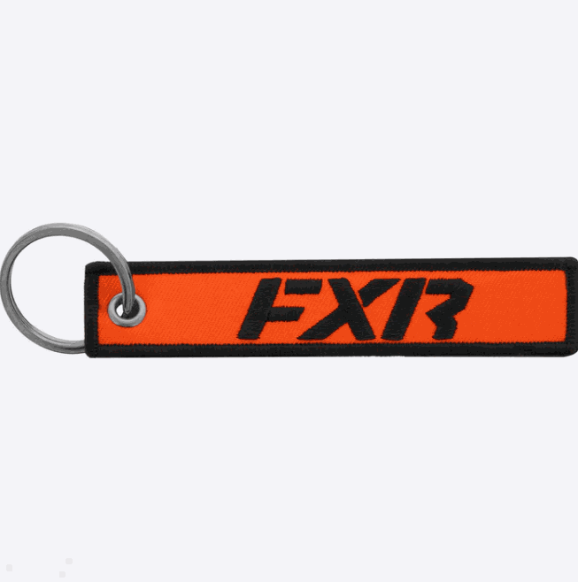 FXR Flight Tag 24 keychain with orange and black design.