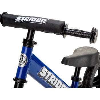 Close-up of blue STRIDER 12" Sport Balance Bike handlebars and seat, lightweight toddler bike for ages 18 months to 5 years