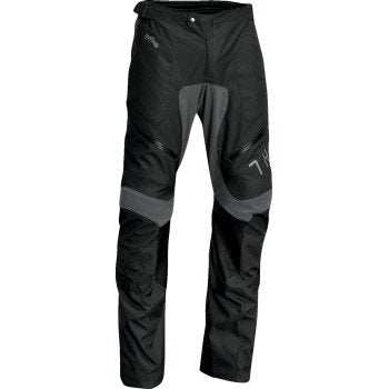 THOR Terrain Over-the-Boot Pants in black with reinforced knees, waterproof zippers, and adjustable waist cinches designed for durability and flexibility.