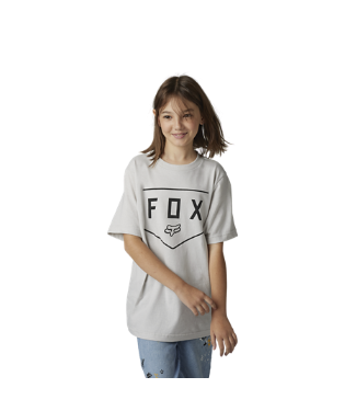 A youth wearing a white FOX Racing t-shirt with a graphic design in the center, paired with blue jeans.