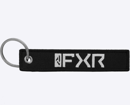 Black FXR Flight Tag keychain with white logo and metal ring