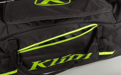 Black and neon green KLIM Drift Gear Bag with large zippered compartments and padded carrying straps