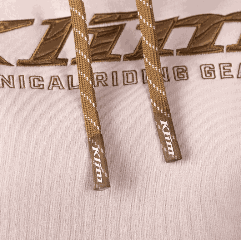 Close-up of KLIM Morley Pullover Hoodie showing brown drawcords and embroidered logo on polyester bonded fleece fabric